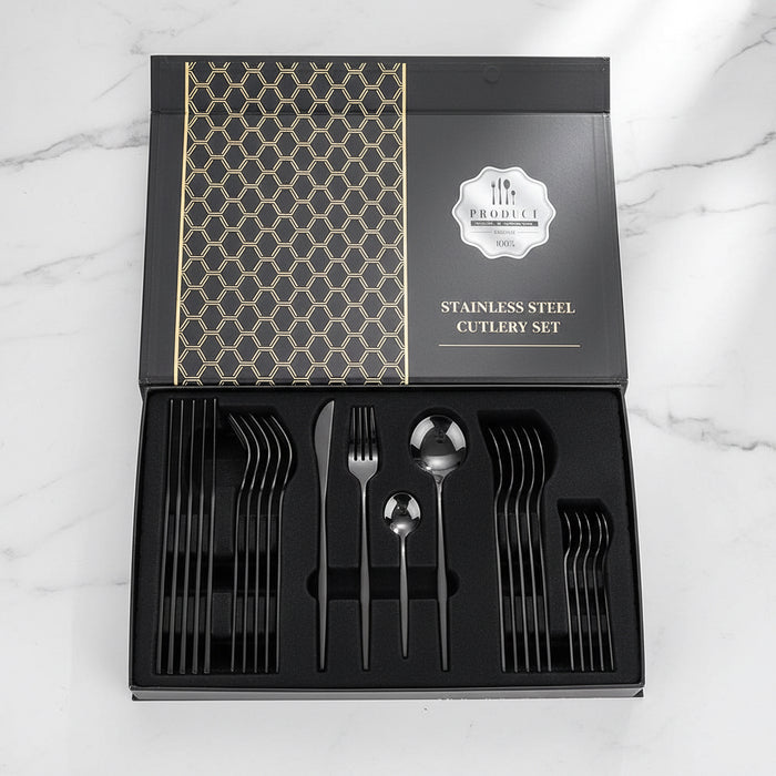 24-piece black stainless steel flatware set displayed in a gift box on countertop