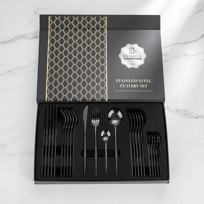 24-piece black stainless steel flatware set displayed in a gift box on countertop