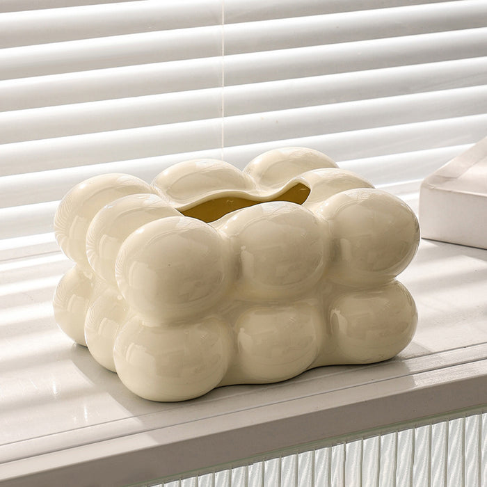 Cream white bubble ceramic tissue box cover displayed on a white table