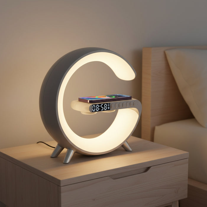 White circular LED bedside lamp with warm ambient light, digital clock, and smartphone on wireless charging platform
