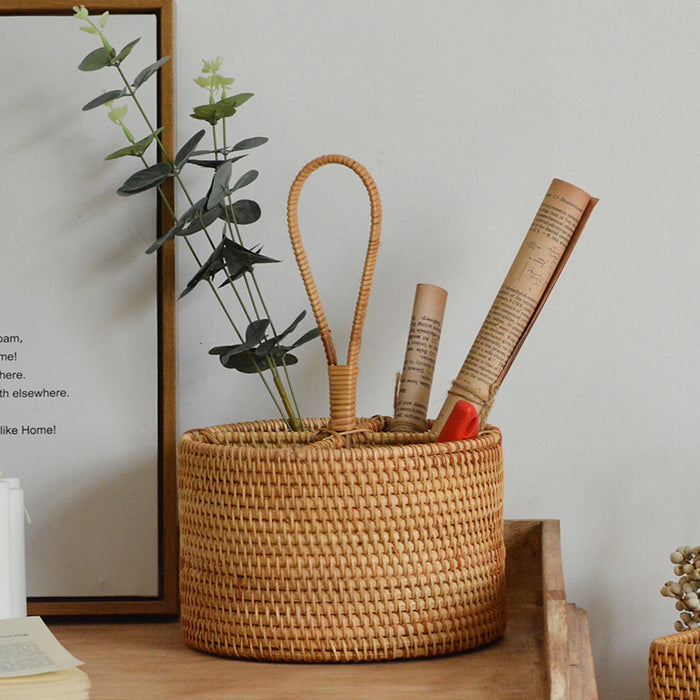 Round handwoven rattan storage basket with carrying handle used for books, plants, and home organization