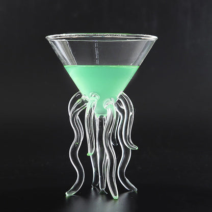 Clear jellyfish cocktail glass with flowing tentacle stem and green drink