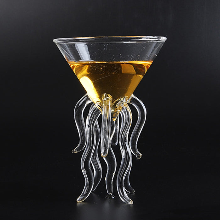 Sculpted jellyfish cocktail glass with tentacle base holding an amber drink