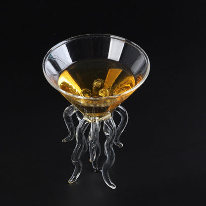 Angled top view of a jellyfish cocktail glass with an amber drink