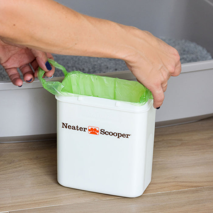Person removing the Neater Scooper bag from the Neater Scooper bin.