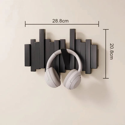 Decorative black wooden wall mounted coat rack shown in on wall will white headphones hanging on it and the dimensions on top and side