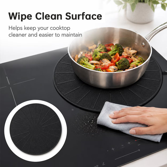 Black silicone induction cooktop protector mat positioned under a stainless steel frying pan