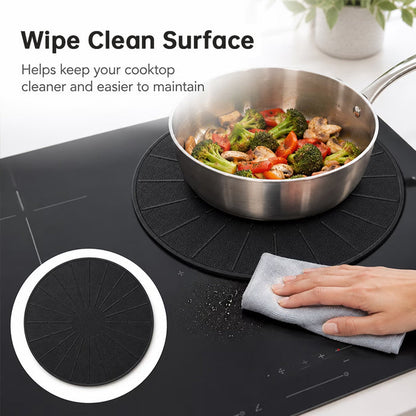 Black silicone induction cooktop protector mat positioned under a stainless steel frying pan